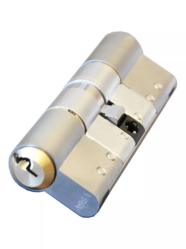 En närbild av en metallcylinder med en nyckel insatt, mot en vit bakgrund.